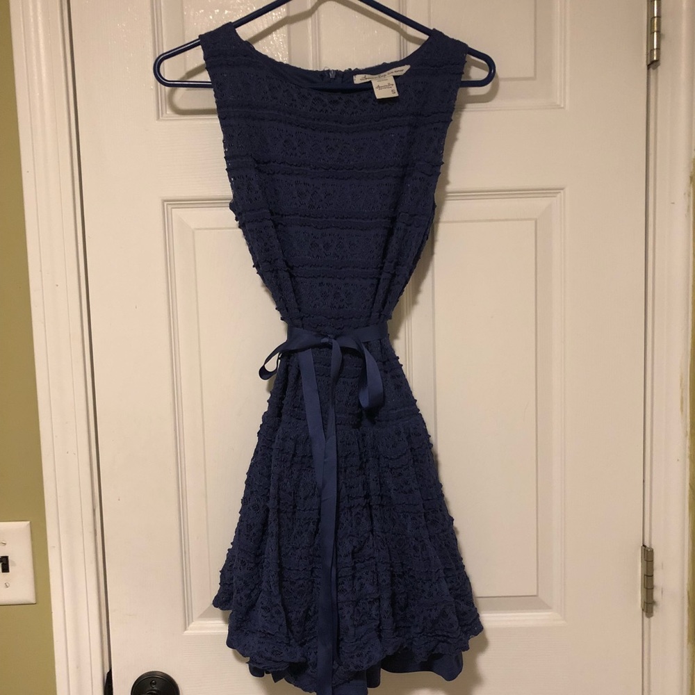A navy lace dress with ribbon.